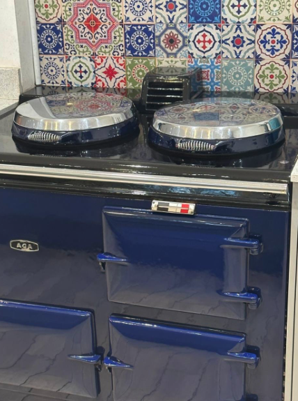 Blue Aga with gleaming stainless steel covers