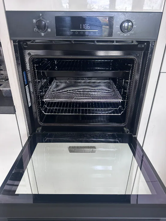 Clean single oven cavity, door glass, racks, and trays in Long Lawford