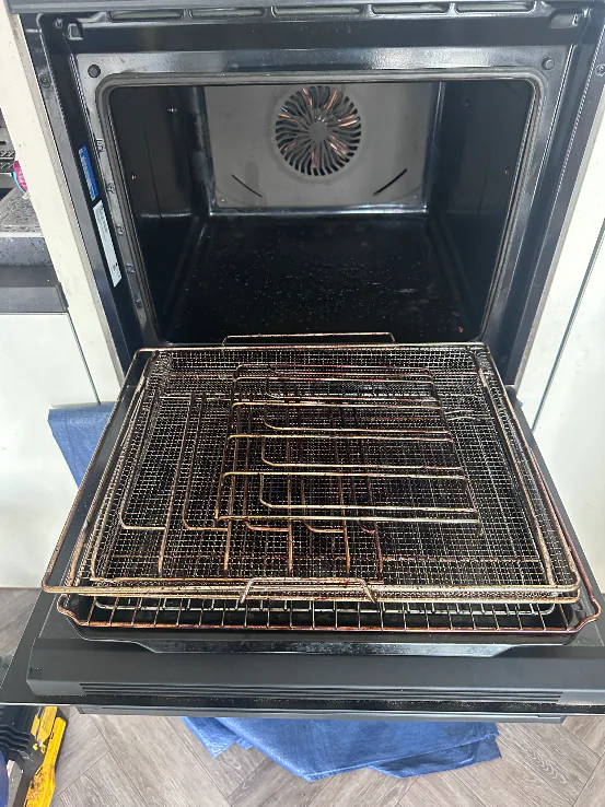 Greasy single oven racks and trays before cleaning in Long Lawford