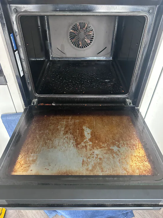 Single oven cavity and marked door glass before cleaning in Long Lawford